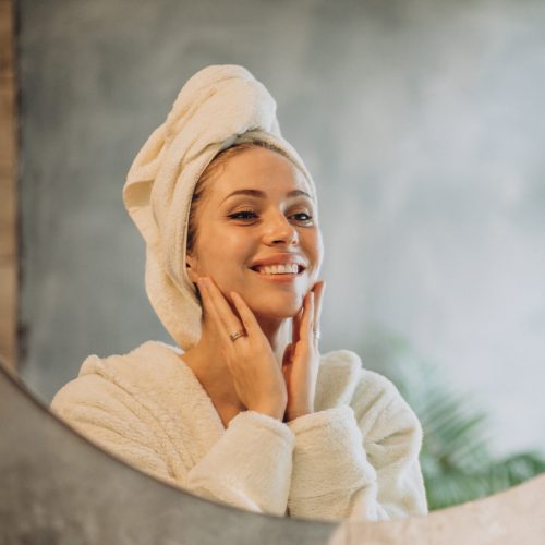 Woman at home applying cream mask